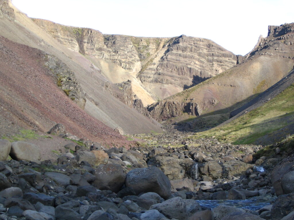 Rocky gorge with steep scree slopes and outcrops near Húsafell in West Iceland, the Bæjargil ravine.