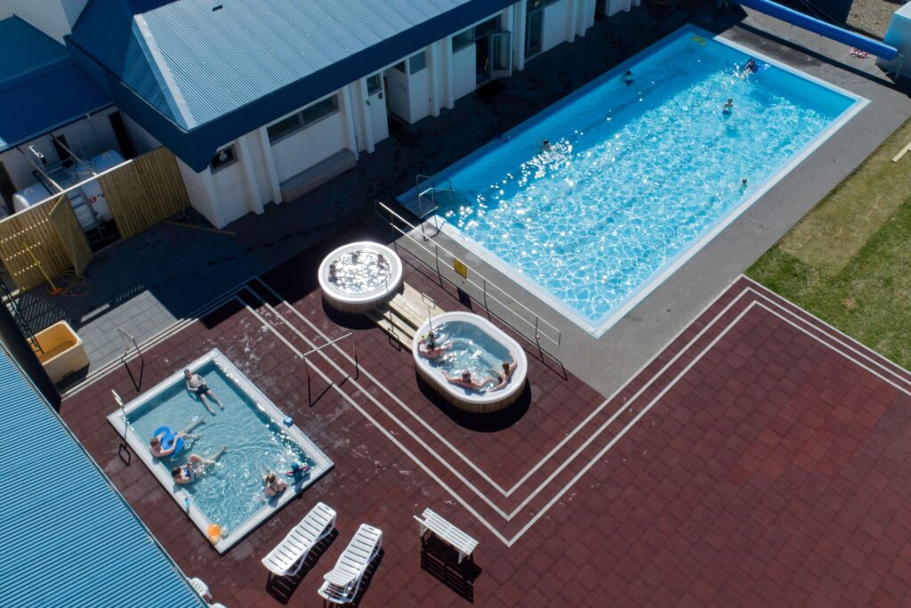 A small-town outdoor geothermal swimming pool in West Iceland