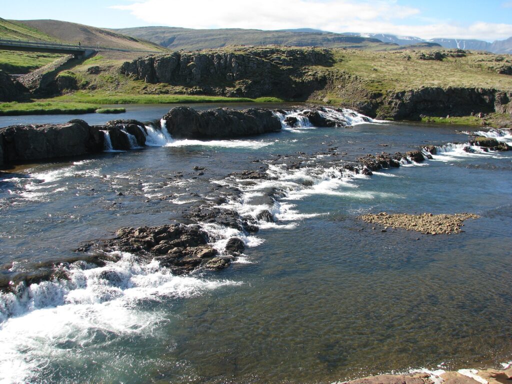 Tröllafossar rapids on the Grímsá river at Fossatún in Borgarfjörður, West Iceland, with water tumbling over dark rock formations.