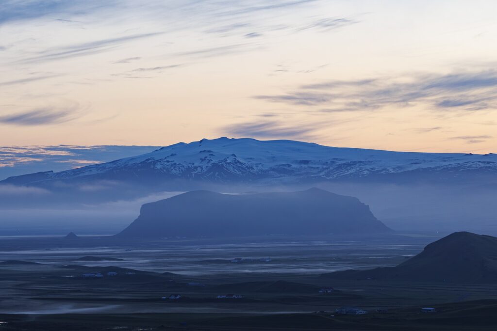 A misty Icelandic landscape under low golden summer-night light, photographed at 02:10 in late June during the midnight sun.
