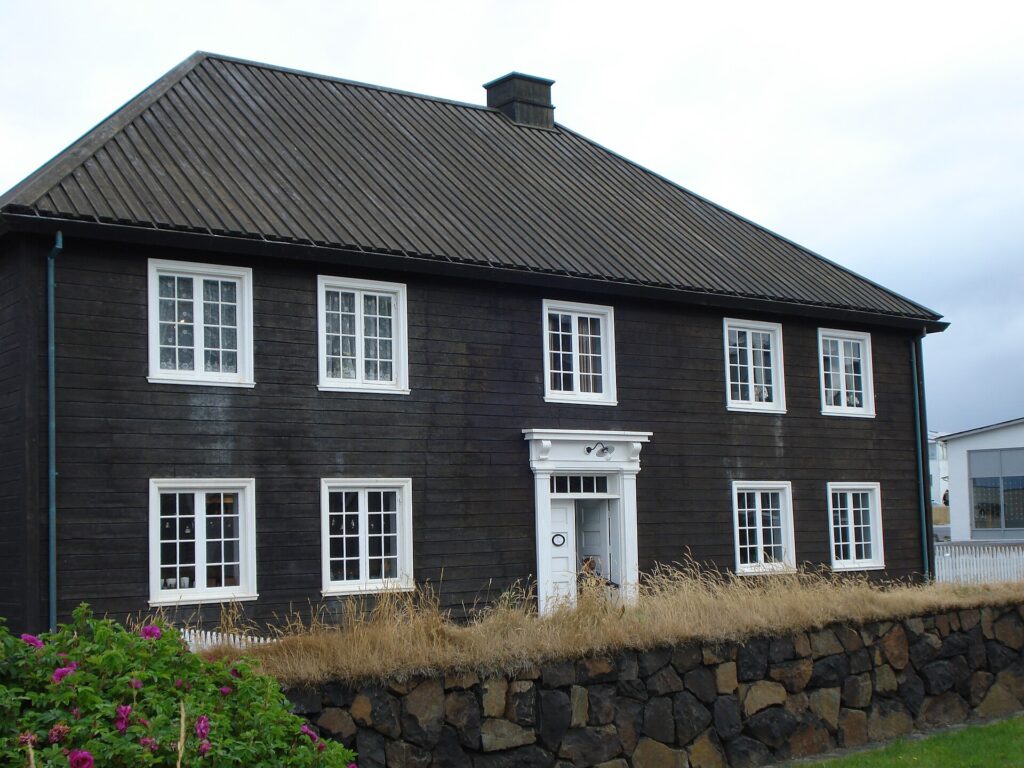 The Norwegian House (Norska húsið), a two-storey white timber building with a steep dark roof, in Stykkishólmur, Iceland