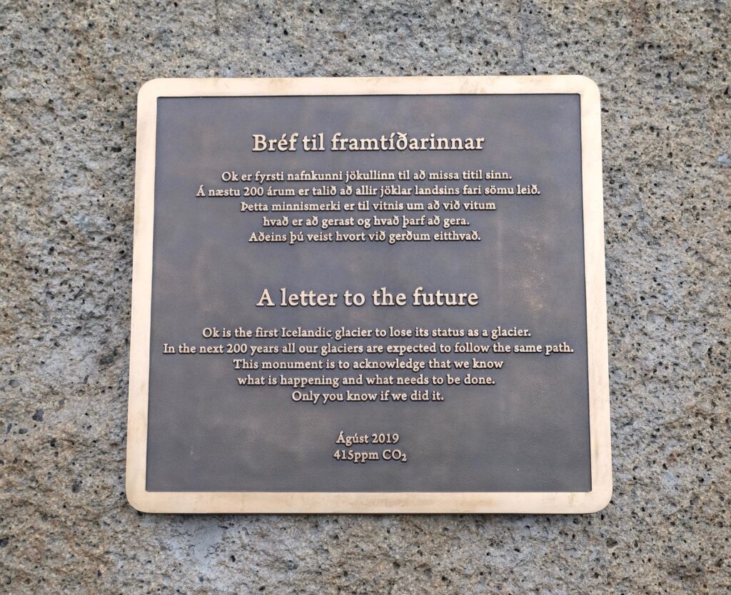 The bronze Okjökull memorial plaque, titled "A letter to the future", bolted to a rock on the summit of Ok in Iceland.