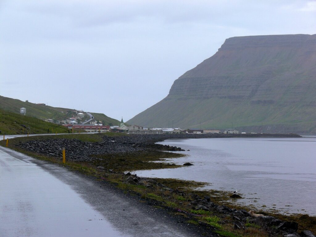 The fishing village of Suðureyri on Súgandafjörður, Iceland, with the mountain Góltur rising behind the harbour and houses